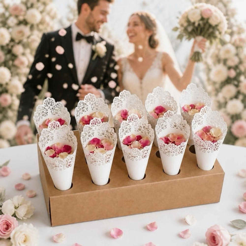 Decorative cones with flowers in front of a couple in wedding attire.
